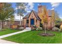 Charming brick home with manicured lawn and a beautiful tree in the front yard at 4710 W 32Nd Ave, Denver, CO 80212