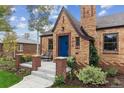 Close up of brick house with front porch and blue door at 4710 W 32Nd Ave, Denver, CO 80212