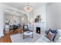 Bright living room features a fireplace, chandelier, and hardwood floors at 568 Galapago St, Denver, CO 80204