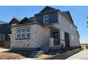 This two-story home showcases attractive siding and stone accents, and features a cozy covered front porch at 23762 E 33Rd Pl, Aurora, CO 80019