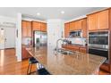 Well-appointed kitchen features a large island, stainless steel appliances, and ample cabinet space at 14805 Quince Way, Thornton, CO 80602