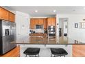Well-appointed kitchen features a large island, stainless steel appliances, and ample cabinet space at 14805 Quince Way, Thornton, CO 80602