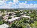 Aerial view of condo complex with mature landscaping and mountain views at 5995 W Hampden Ave # 18C, Denver, CO 80227