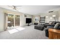 Bright living room featuring sliding glass door and comfortable seating at 5995 W Hampden Ave # 18C, Denver, CO 80227