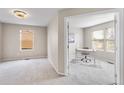 Neutral office with bright natural light, neutral paint, and neutral carpeted floors at 10049 Granby Dr, Commerce City, CO 80022