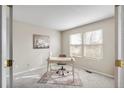 Well-lit home office with a desk, chair, decor, and multiple windows, creating an ideal workspace at 10049 Granby Dr, Commerce City, CO 80022