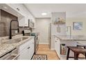Modern kitchen with stainless steel appliances, granite countertops, stylish backsplash and convenient island seating at 2500 S York St # 102, Denver, CO 80210