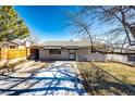 Front view of a charming ranch home with a fenced yard at 3446 S Clay St, Englewood, CO 80110