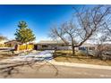 House exterior showcasing a well-maintained lawn and landscaping at 3446 S Clay St, Englewood, CO 80110