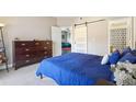 Comfortable bedroom with a sliding door and a view of the living room at 8653 E Dry Creek Rd # 1114, Englewood, CO 80112