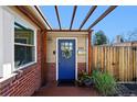 Inviting entrance with a blue front door, welcome mat, and a decorative wreath at 2301 E Yale Ave, Denver, CO 80210