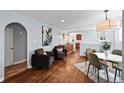 Open-concept living and dining area with hardwood floors and modern furnishings at 2301 E Yale Ave, Denver, CO 80210