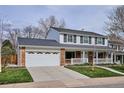 Lovely two-story home with brick accents, attached garage, and a well-maintained front yard at 7343 S Ivy Way, Centennial, CO 80112