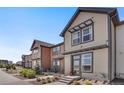 View of a series of modern townhomes with a sidewalk and tidy landscaping at 11440 E Martin Luther King Jr Blvd, Denver, CO 80238