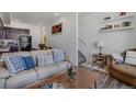 Cozy living room with modern furnishings, decor, and open access to the kitchen and staircase at 11440 E Martin Luther King Jr Blvd, Denver, CO 80238
