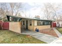 Brick exterior home featuring a covered carport with a well-manicured lawn at 3050 S Marion St, Englewood, CO 80113