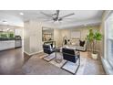 Open concept living room boasts ceiling fan, stylish furniture, and adjoins modern kitchen at 9346 Flower St, Broomfield, CO 80021