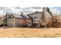 Charming two-story home with a well-manicured lawn and classic architectural details at 9182 Weeping Willow Ct, Highlands Ranch, CO 80130