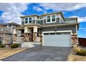 Beautiful two-story home with a well-manicured lawn, gray siding, and a two-car garage at 12164 Poplar St, Thornton, CO 80602