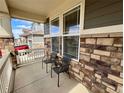 Charming front porch with stone accents and seating, offering a cozy outdoor space at 12164 Poplar St, Thornton, CO 80602