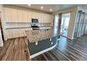 Modern kitchen with granite countertops, stainless steel appliances, and a large center island at 12164 Poplar St, Thornton, CO 80602