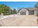 House exterior showcasing a snow-covered driveway and a three-car garage at 44 Spyglass Dr, Littleton, CO 80123