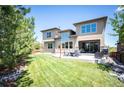 Spacious backyard with a green lawn and patio area, perfect for outdoor living at 350 Andromeda Ln, Castle Rock, CO 80108