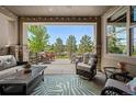 Inviting covered patio with comfortable seating and a view of the backyard at 350 Andromeda Ln, Castle Rock, CO 80108