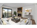 Inviting living room featuring a stone fireplace, stylish furniture, and access to an outdoor patio at 7665 E Eastman Ave # D304, Denver, CO 80231