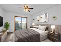 Bright main bedroom features a ceiling fan, sliding glass door and comfortable contemporary decor at 7665 E Eastman Ave # D304, Denver, CO 80231