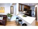 Bright, open kitchen with breakfast bar, sleek countertops, and stainless steel appliances at 4878 E Kentucky Ave # A, Denver, CO 80246