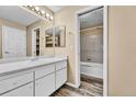Bathroom featuring modern vanity, walk-in closet, and tub shower at 8065 W Eastman Pl # 6-102, Denver, CO 80227
