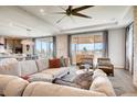 Open-concept living room with comfortable seating, large windows with scenic views, and stylish modern décor at 13806 Honey Hush Trl, Parker, CO 80134