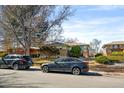 Lovely home exterior with well-kept lawn, mature tree, and street parking at 1173 Dallas St, Aurora, CO 80010