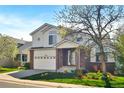 Charming two-story home with a brick-accented facade, a well-manicured lawn, and an attached two-car garage at 5929 Dunraven Way, Golden, CO 80403