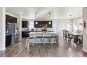 Spacious kitchen with a center island, stainless steel appliances, and a dining area at 18809 W 92Nd Dr, Arvada, CO 80007