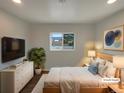 Bright bedroom with white and wood furniture, recessed lights and a window at 6757 Lee St, Arvada, CO 80004