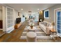 Modern living room with stone fireplace, recessed lighting, and neutral decor at 6757 Lee St, Arvada, CO 80004