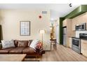 Cozy living area featuring a modern kitchen, comfortable seating, and stylish decor at 603 Inca St # 432, Denver, CO 80204