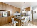 Modern kitchen with stainless steel appliances, hardwood floors, an island and pendant lighting at 79 Huron Ct, Boulder, CO 80303