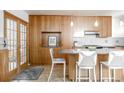 Kitchen boasts a stylish island with bar seating, stainless appliances and hardwood floors at 79 Huron Ct, Boulder, CO 80303