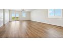 Spacious living room with hardwood floors, large windows, and a double door that lead to the yard at 42998 Colonial Trl, Elizabeth, CO 80107