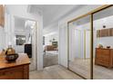 Bright hallway showcases tile flooring, mirrored closet doors, and access to living areas at 555 E 10Th Ave # 15, Denver, CO 80203