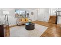 Living room with hardwood floors, comfy seating, and a view of the entryway at 6675 S Apache Dr, Littleton, CO 80120