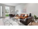 Bright living room features stylish furniture, a patterned rug, and natural light, creating an inviting atmosphere at 1308 Stuart St, Denver, CO 80204