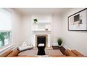 Stylish living room showcasing a classic fireplace, modern decor, and ample natural light at 3071 W 38Th Ave, Denver, CO 80211
