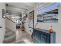Bright entryway with wood flooring and a staircase leading to the second floor at 10232 Yampa Ct, Commerce City, CO 80022