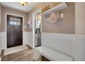 Warm and inviting foyer with hardwood floors, featuring a convenient bench and storage shelf at 748 S Grape St, Denver, CO 80246