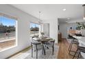 Charming dining area with a round table, stylish chairs, and natural light from two windows at 1337 N Alton St, Aurora, CO 80010