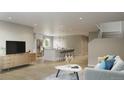 Spacious living room with an open floor plan, seamlessly connecting the kitchen and dining area with modern finishes at 1337 N Alton St, Aurora, CO 80010